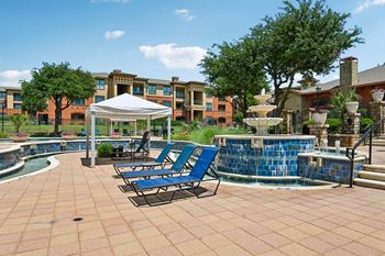 Oversized resort style swimming pool with cascading fountains